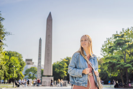 Woman Tourist in Istanbul against the background of Obelisk of Theodosius is the Ancient Egyptian...