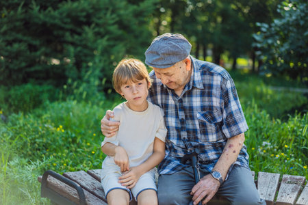Great-grandfather and great-grandson spend time together in the parkの写真素材