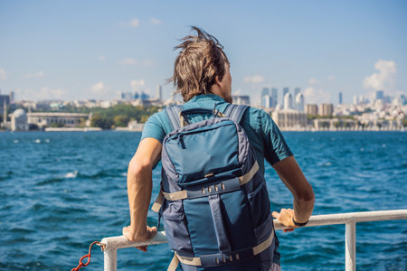 Happy man enjoying the sea from ferry boat crossing Bosphorus in Istanbul. Summer trip to Istanbulの写真素材