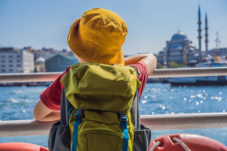 Happy boy enjoying the sea from ferry boat crossing Bosphorus in Istanbul. Summer trip to Istanbul. Traveling with kids conceptの写真素材