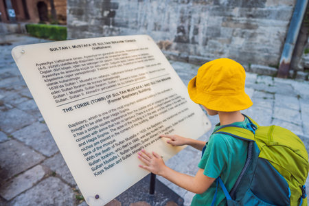 The boy looks at the information on the plate