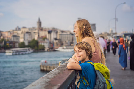 Portrait of beautiful mother and son tourists with view of Galata tower in Beyoglu, Istanbul, Turkey. Turkiye. Traveling with kids conceptの写真素材