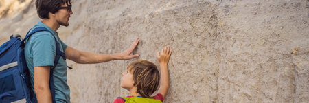 BANNER, LONG FORMAT Father and son tourists on background of Unique geological formations in Love Valley in Cappadocia, popular travel destination in Turkey. Traveling with children in Turkey conceptの写真素材