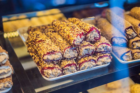 Traditional oriental sweet pastry cookies, nuts, dried fruits, pastilles, marmalade, Turkish desert with sugar, honey and pistachio, in display at a street food marketの写真素材