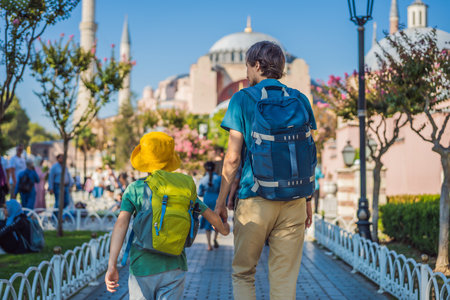Father and son Tourists enjoy beautiful view on Hagia Sophia Cathedral, famous islamic Landmark mosque, Travel to Istanbul, Turkey. Traveling with kids concept. Sunny day architecture and Hagia Sophia Museum, in Eminonu, istanbul, Turkey. Turkiyeの写真素材