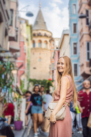 Portrait of beautiful woman tourist with view of Galata tower in Beyoglu, Istanbul, Turkey. Turkiyeの写真素材