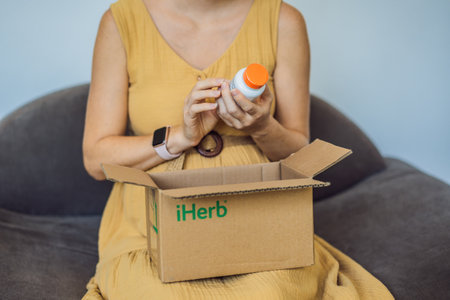 12.16.22, USA, Miami: A pregnant woman received an iherb package. doctors best vitamin D3. Vitamins and minerals for a healthy pregnancy at iherbのeditorial素材