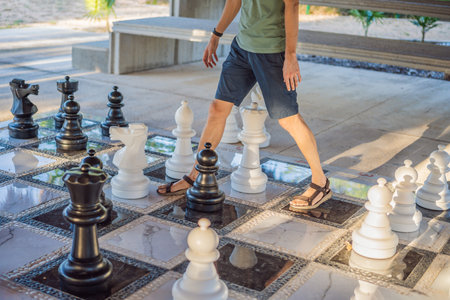 Father and son playing chess spending time together outdoor. Kid play chessの写真素材