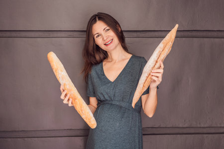 Happy and healthy pregnant woman after 40 embracing a gluten-free lifestyle during her pregnancy journey. Nourishing choices for a thriving baby and momの写真素材
