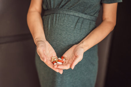 A glowing pregnant woman proudly displaying her carefully chosen maternity dietary supplements, prioritizing her and her babys healthの写真素材