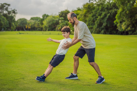 A touching trust exercise as a son falls back into his fathers arms, demonstrating unwavering trust and the bond between parent and childの写真素材