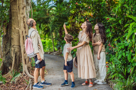 A loving family enjoying a leisurely walk in the park - a radiant pregnant woman after 40, embraced...