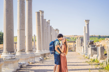 Loving couple of tourists at the ruins of ancient city of Perge near Antalya Turkey. Traveling with kids conceptの写真素材