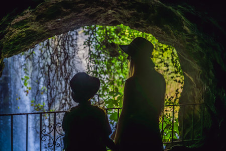 mother and son tourists on the background of Duden waterfall in Antalya. Famous places of Turkey. Apper Duden Falls.の写真素材