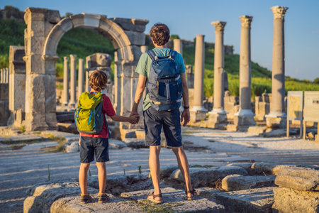 dad and son tourists at the ruins of ancient city of Perge near Antalya Turkey. Traveling with kids conceptの写真素材