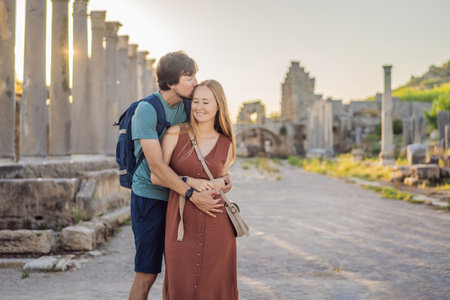 Loving couple of tourists at the ruins of ancient city of Perge near Antalya Turkey. Traveling with kids conceptの写真素材