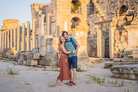Loving couple of tourists at the ruins of ancient city of Perge near Antalya Turkey. Traveling with kids conceptの写真素材
