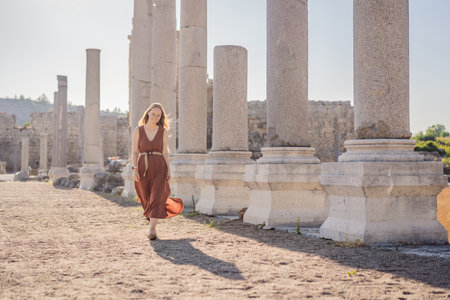 Pretty tourist woman at the ruins of ancient city of Perge near Antalya Turkeyの写真素材