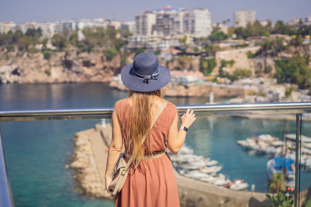Happy woman tourist on background of old street of Antalya. female tourist traveler discover interesting places and popular attractions and walks in the old city Kalechi of Antalya, Turkey. Turkiyeの写真素材
