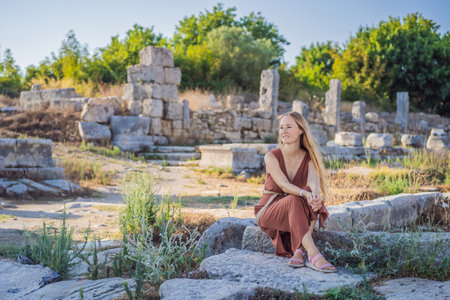 Pretty tourist woman at the ruins of ancient city of Perge near Antalya Turkeyの写真素材