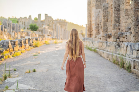 Pretty tourist woman at the ruins of ancient city of Perge near Antalya Turkeyの写真素材