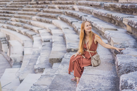 Woman tourist explores Aspendos Ancient City. Aspendos acropolis city ruins, cisterns, aqueducts and old temple. Aspendos Antalya Turkey. turkiyeの写真素材
