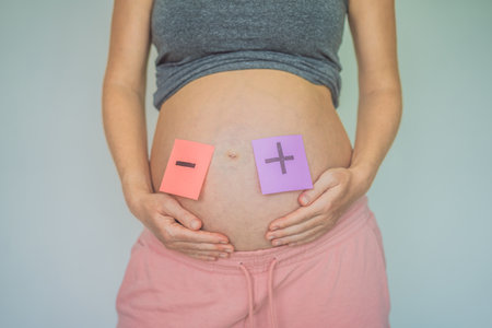 A pregnant mother faces Rhesus conflict with her child, highlighting the complex challenges of maternal and fetal blood type incompatibilityの写真素材
