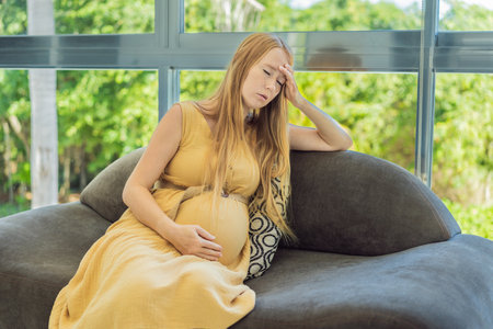 Expectant woman experiences discomfort, feeling unwell during pregnancyの写真素材