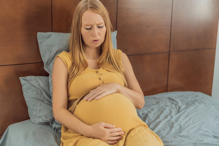 Expectant woman experiences discomfort, feeling unwell during pregnancyの写真素材