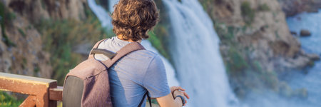 BANNER, LONG FORMAT Man tourist on the background of Duden waterfall in Antalya. Famous places of...