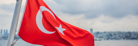 Turkish flag flying in the wind against the background of the sea and the coast BANNER, LONG FORMAT