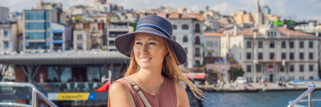 Happy woman enjoying the sea from ferry boat crossing Bosphorus in Istanbul. Summer trip to Istanbul BANNER, LONG FORMATの写真素材