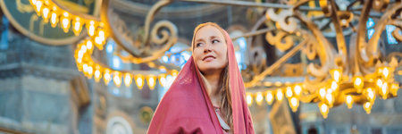 BANNER, LONG FORMAT denoting the names of Allah, the Prophet Muhammad, as well as the first 4 caliphs Woman tourist enjoying Hagia Sofia, Ayasofya interior in Istanbul, Turkey, Byzantine architecture, city landmark and architectural world wonder. Turkiyeの写真素材