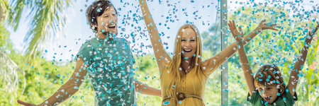 BANNER, LONG FORMAT Its a boy. Expectant parents mother, father and their elder son are having a gender reveal party. A married the couple burst the balloon and the blue confetti flew out. Family, pregnancy and prenatal care conceptの写真素材