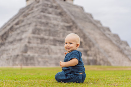 Baby traveler, tourists observing the old pyramid and temple of the castle of the Mayan architecture...