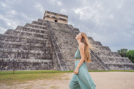 Beautiful tourist woman observing the old pyramid and temple of the castle of the Mayan architecture...