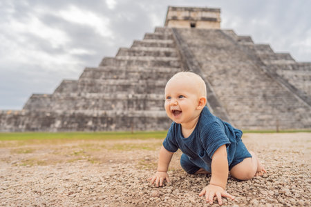 Baby traveler, tourists observing the old pyramid and temple of the castle of the Mayan architecture...