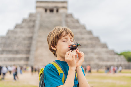 Boy traveler, tourists observing the old pyramid and temple of the castle of the Mayan architecture...