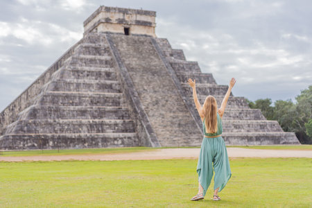 Beautiful tourist woman observing the old pyramid and temple of the castle of the Mayan architecture...