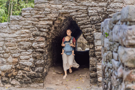 Mother and son tourists at Coba, Mexico. Ancient mayan city in Mexico. Coba is an archaeological area and a famous landmark of Yucatan Peninsula. Cloudy sky over a pyramid in Mexicoの写真素材