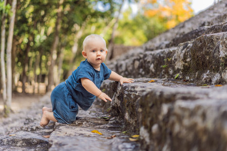 Baby tourist at Coba, Mexico. Ancient mayan city in Mexico. Coba is an archaeological area and a famous landmark of Yucatan Peninsula. Cloudy sky over a pyramid in Mexicoの写真素材