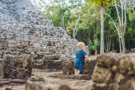 Baby tourist at Coba, Mexico. Ancient mayan city in Mexico. Coba is an archaeological area and a famous landmark of Yucatan Peninsula. Cloudy sky over a pyramid in Mexicoの写真素材