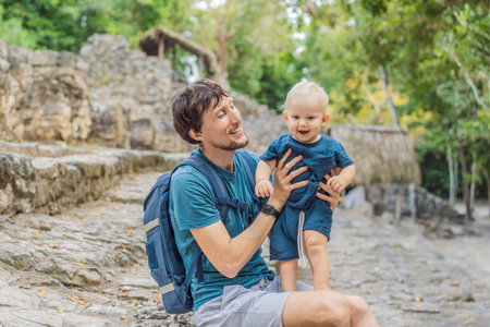 Dad and son tourists at Coba, Mexico. Ancient mayan city in Mexico. Coba is an archaeological area and a famous landmark of Yucatan Peninsula. Cloudy sky over a pyramid in Mexicoの写真素材