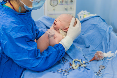 A nurse caring for a newborn baby in a hospital setting. The nurse provides gentle and attentive care, ensuring the babys comfort and well-beingの写真素材