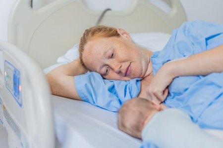 A mom breastfeeds her newborn baby in the hospital. The intimate moment fosters bonding between mother and child, promoting emotional connection and providing essential nourishment for the babys well-beingの写真素材
