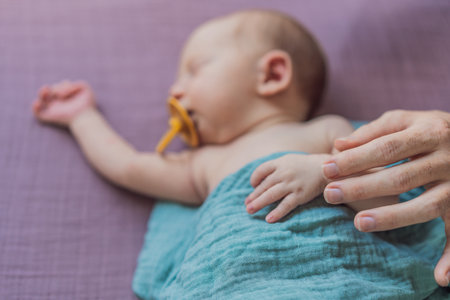 The baby is sleeping peacefully in his cozy nest. Newborn photo session captures the serene innocence and warmth of early momentsの写真素材