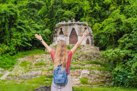 Female tourist exploring the ancient pyramids of Palenque, Mexico, surrounded by dense jungle. Cultural heritage and adventure travel conceptの写真素材
