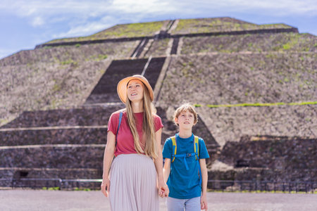 Mother and son tourists exploring Teotihuacan, Mexico. Cultural heritage, ancient ruins, and...