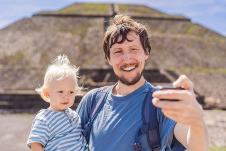 Father and son tourists exploring Teotihuacan, Mexico. Cultural heritage, ancient ruins, and...