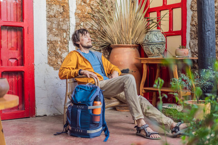 Male tourist in a colonial house in San Cristobal de las Casas, Mexico. Cultural exploration,...